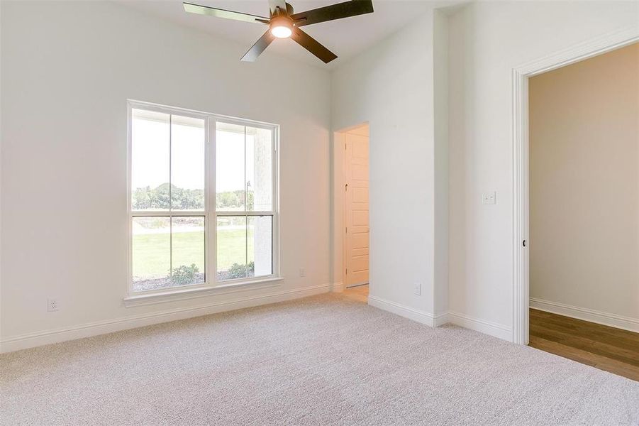 Spare room featuring carpet floors and ceiling fan