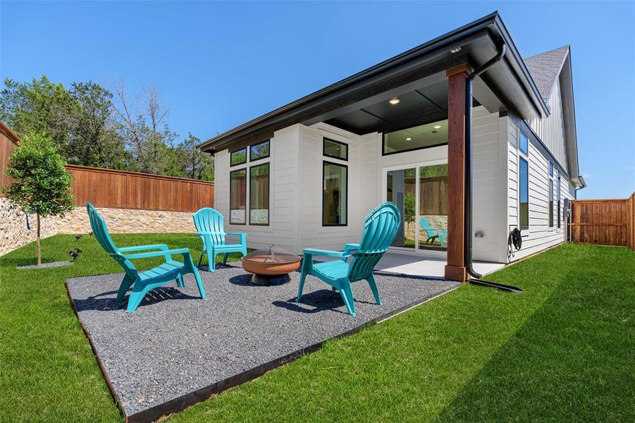 Back of house with a yard, a patio, and an outdoor fire pit