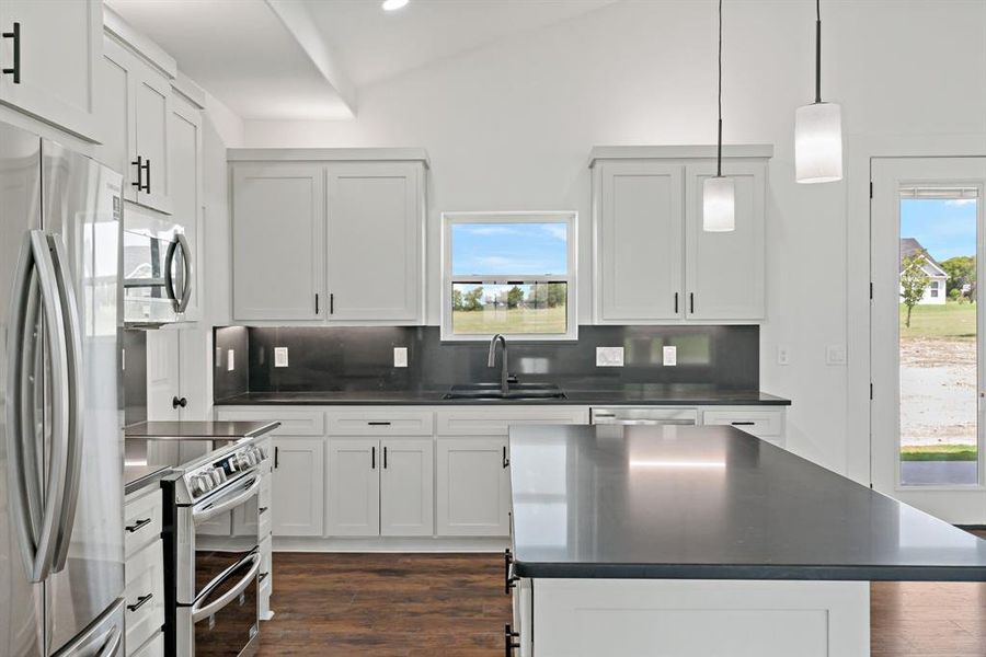 Kitchen featuring decorative backsplash, stainless steel appliances, dark hardwood / wood-style floors, and sink