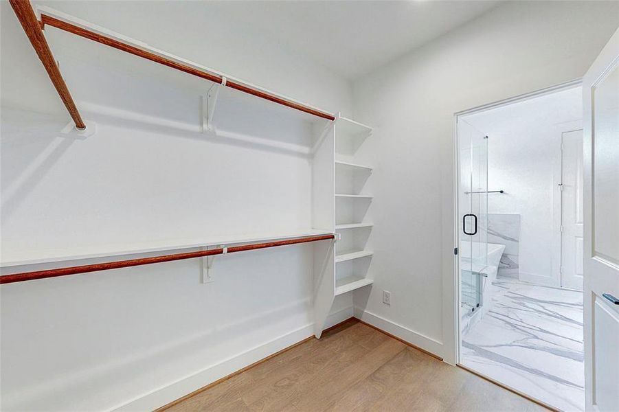 One of two primary closets.Photos of similar completed home by same builder. Selections may differ.