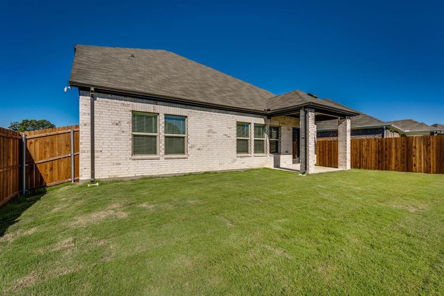 Back of house featuring a yard and a patio area