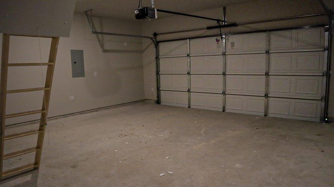 Garage with a garage door opener and electric panel