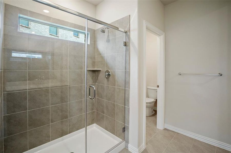 Large shower in primary bathroom with separate toilet room