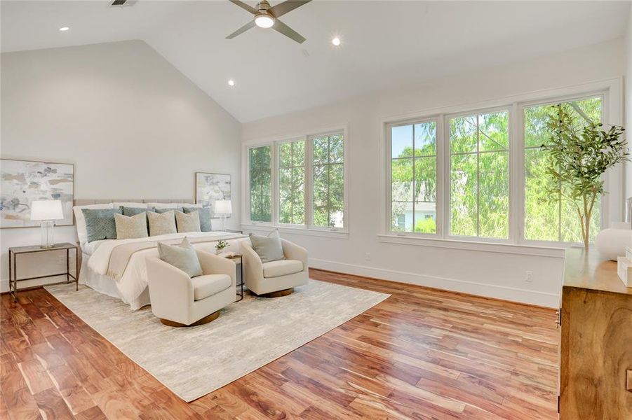 The Primary Bedroom is spacious with a vaulted ceiling, Brazilian Walnut flooring and a wall windows allowing for Wonderful natural light.