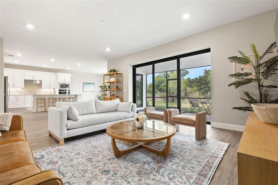 Large pocket sliding glass door in family room overlooks tropical preserve.