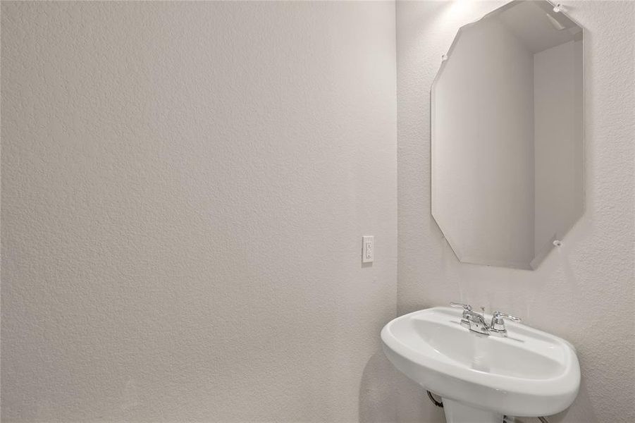 This charming home features a beautifully appointed half bath adjacent to the family room, perfect for welcoming guests and adding convenience to your daily life.