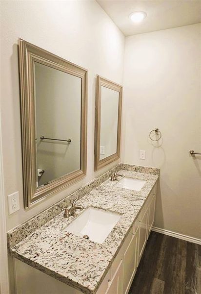 Double sinks, granite counters, framed mirrors- this master bath has it all!