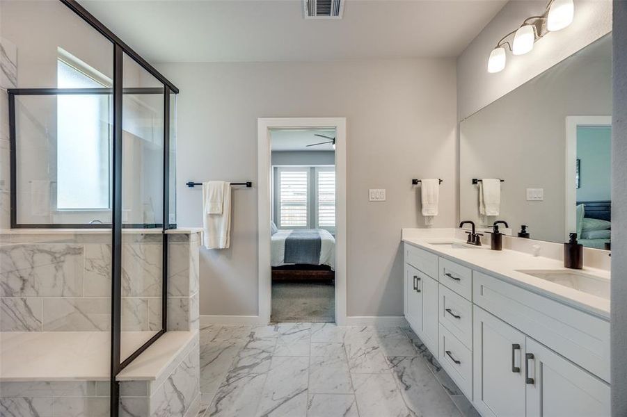 Primary Bathroom featuring vanity and a walk-in shower