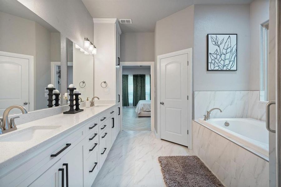 Bathroom with vanity and a relaxing tiled tub