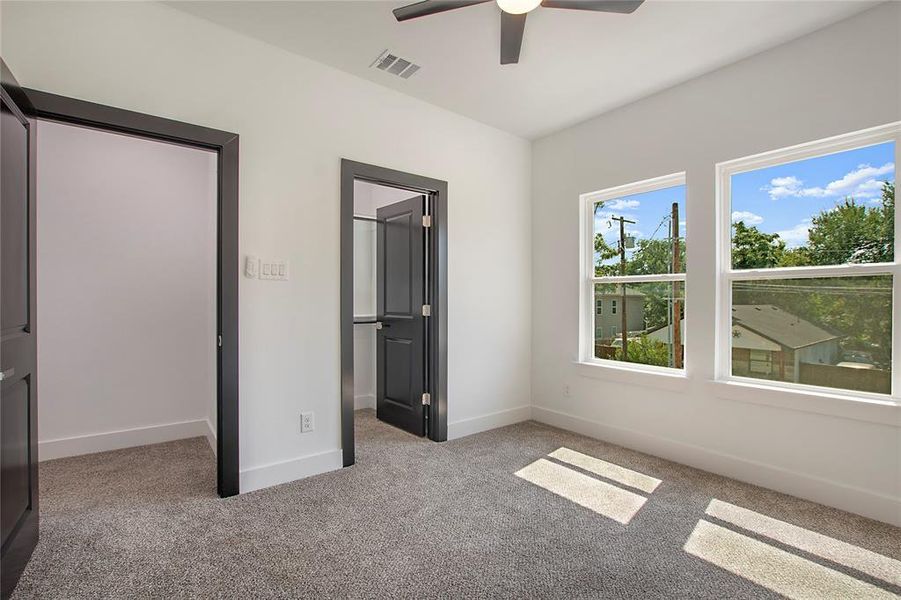 Unfurnished bedroom featuring ceiling fan and light colored carpet