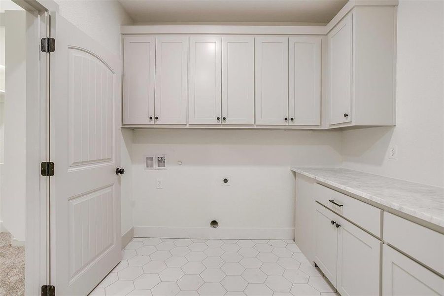 Washroom with washer hookup, gas dryer hookup, electric dryer hookup, and cabinets