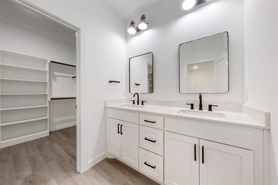 Bathroom featuring hardwood / wood-style flooring and vanity