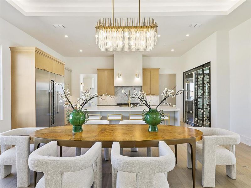 Kitchen with a large island with sink, sink, and light hardwood / wood-style flooring