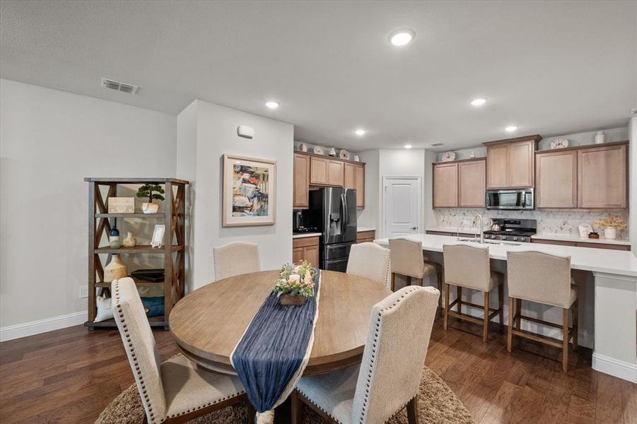 Dining space with dark hardwood / wood-style flooring and sink