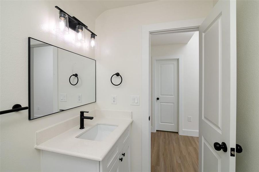 Bathroom with vanity and hardwood / wood-style floors