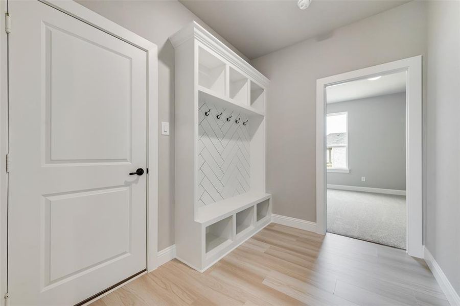 Mudroom featuring light wood-type flooring