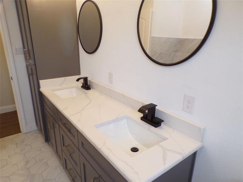 Bathroom featuring tile patterned floors and double vanity