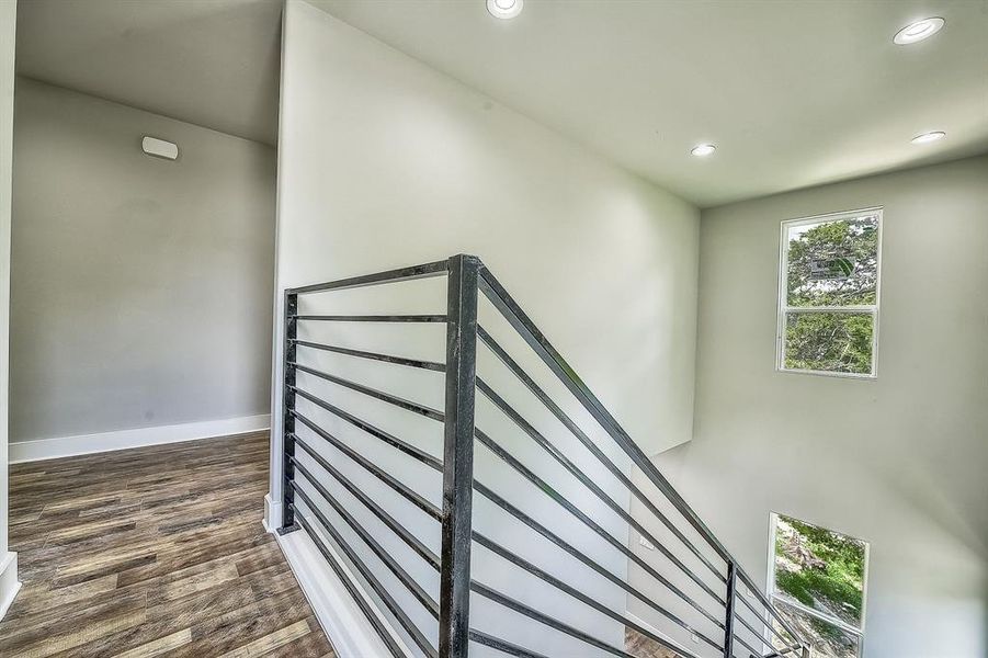 Stairs featuring dark hardwood / wood-style flooring