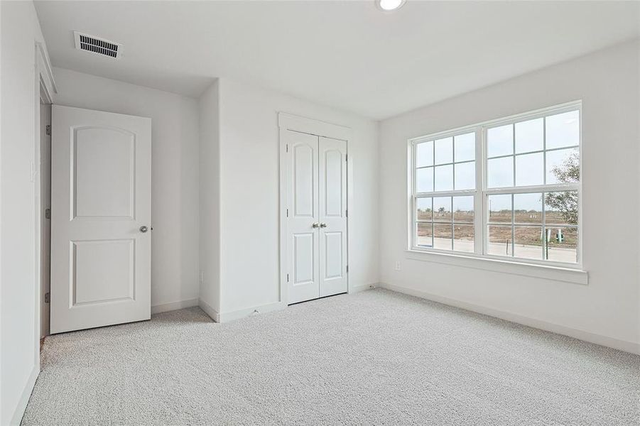 Unfurnished bedroom with a closet and light colored carpet