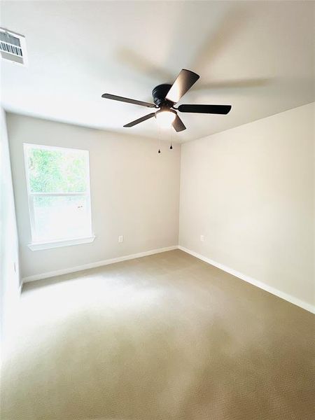 Empty room with carpet floors and ceiling fan