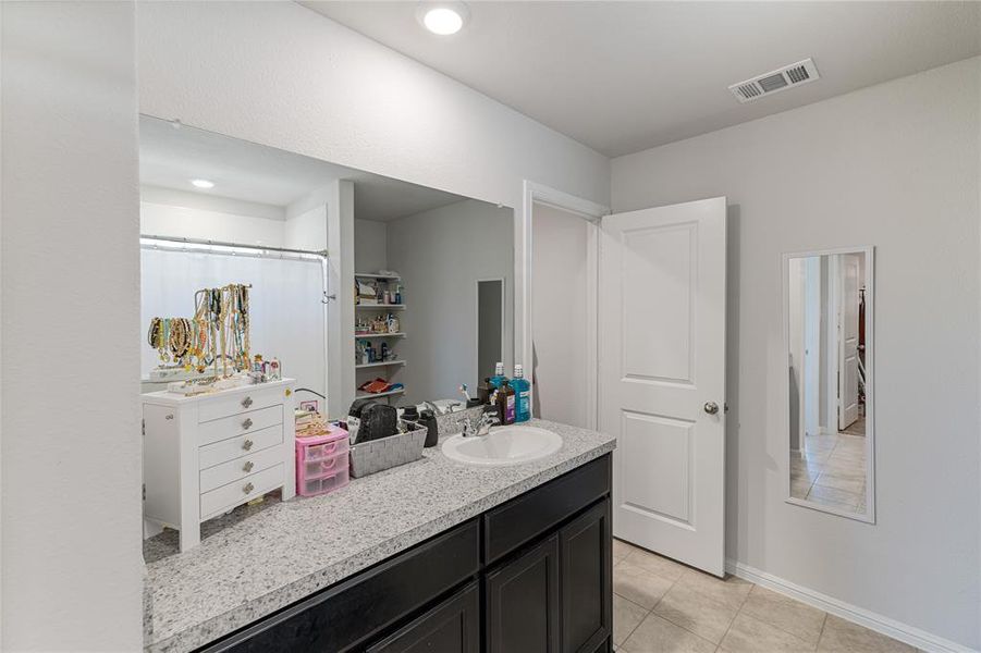 Bathroom featuring vanity and tile patterned floors