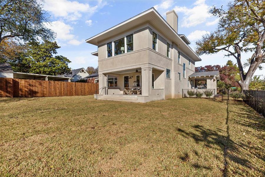 Rear view of property featuring a pergola, a lawn, and a patio area