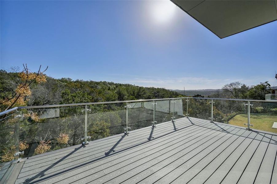 Patio off living room with glass railings