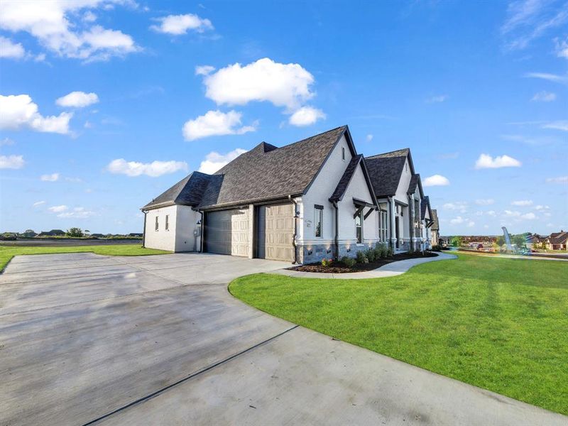 View of front facade with a front lawn and a garage