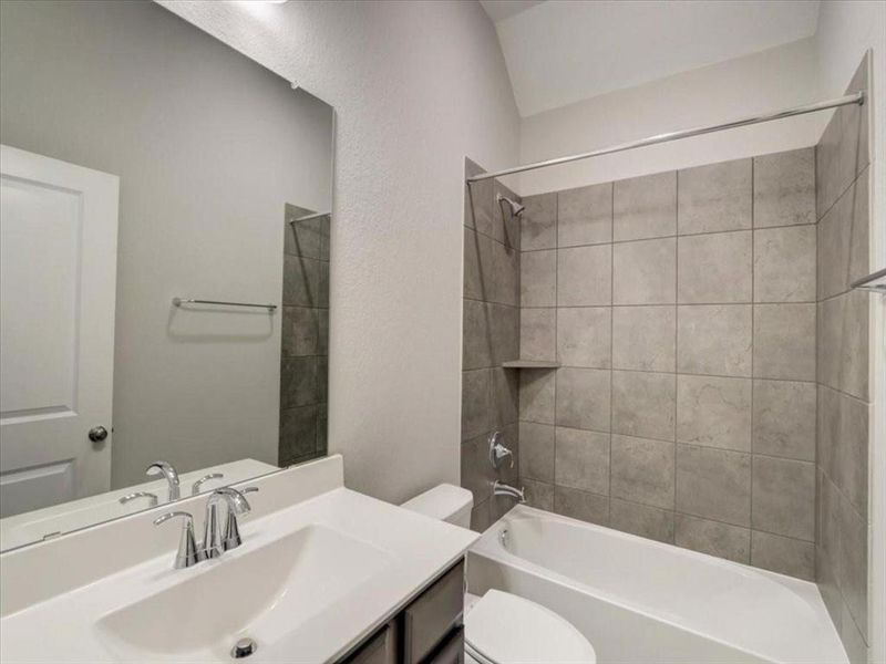 Charming secondary bathroom with a relaxing tub for a soothing retreat.