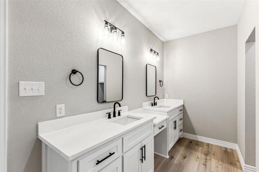 Bathroom with vanity and hardwood / wood-style flooring