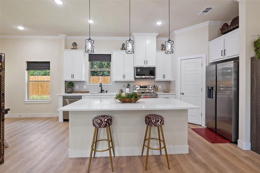 Kitchen featuring stainless steel appliances, granite counters, tasteful backsplash, and sink