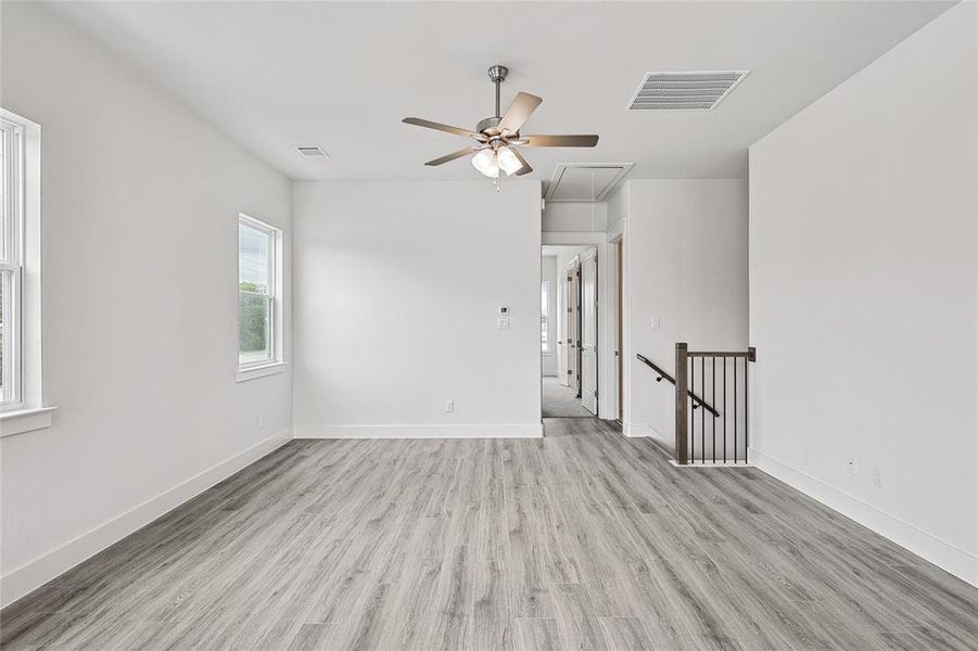 Spare room with ceiling fan and light hardwood / wood-style floors