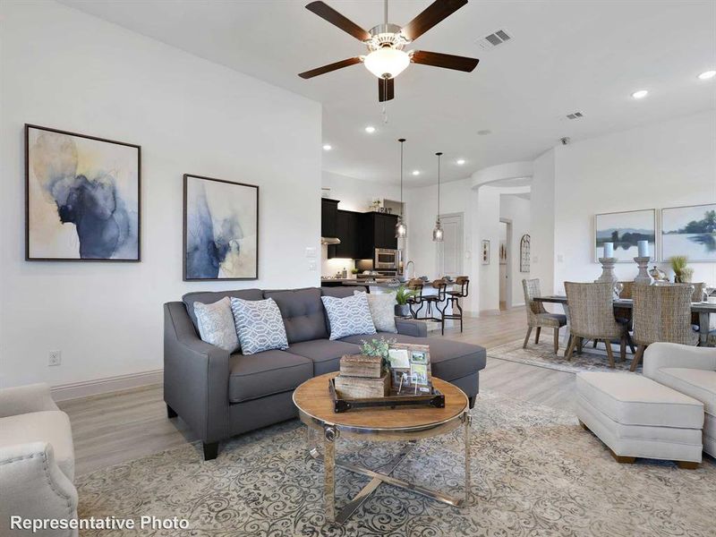 Living room with wood-type flooring and ceiling fan