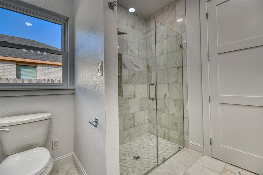 Bathroom featuring toilet and walk in shower