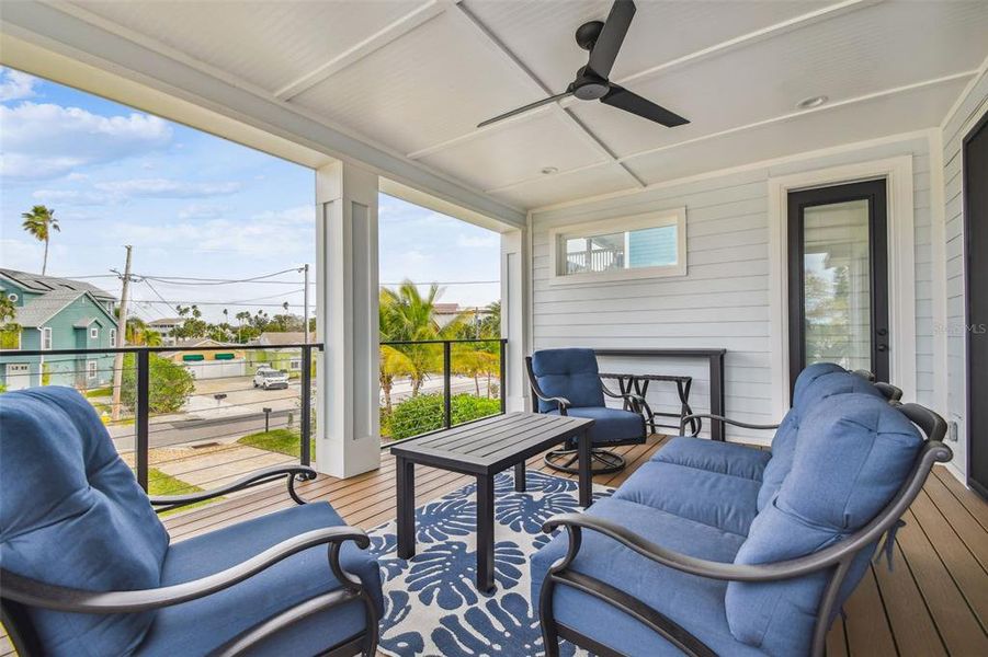 Huge lanai on main living level with ship lap and ceiling fan.
