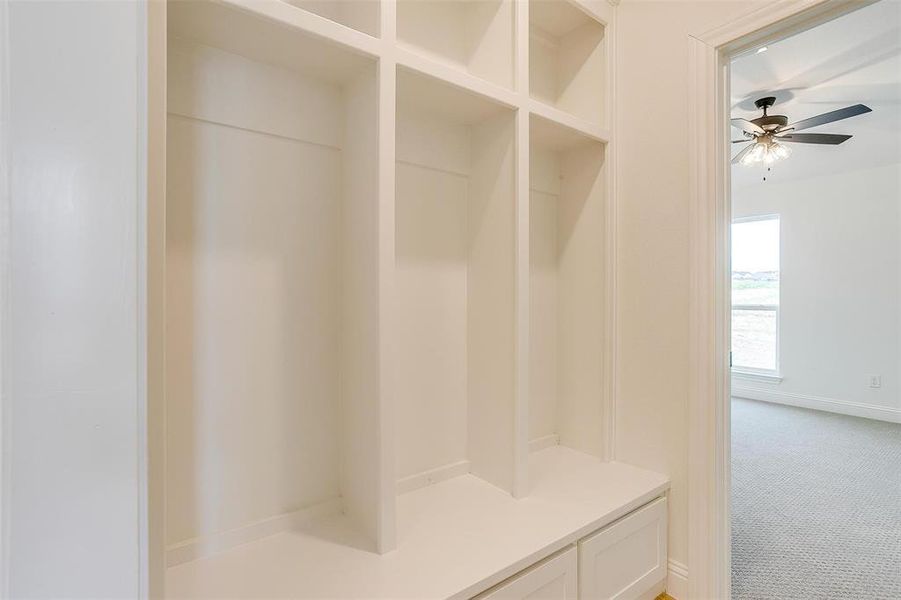 Mudroom featuring ceiling fan and carpet flooring