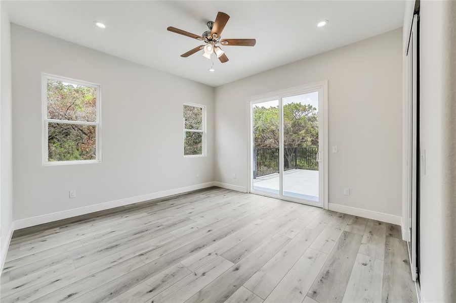 Upstairs bedroom with balcony doors leading to roof top patio.