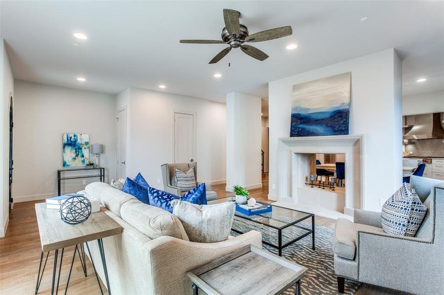 Living room with hardwood / wood-style floors and ceiling fan