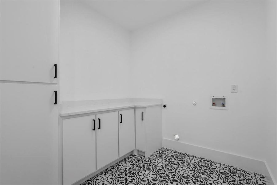 Laundry area featuring light tile patterned flooring, hookup for a washing machine, cabinets, electric dryer hookup, and hookup for a gas dryer