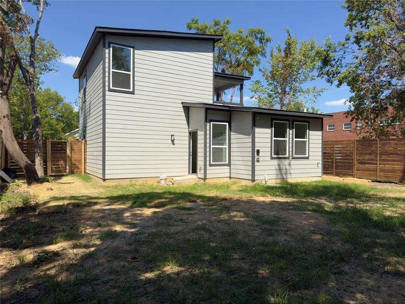 Rear view of property featuring a yard