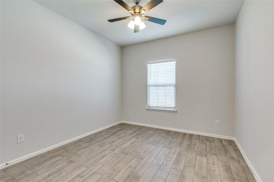 Spare room with light wood-type flooring and ceiling fan