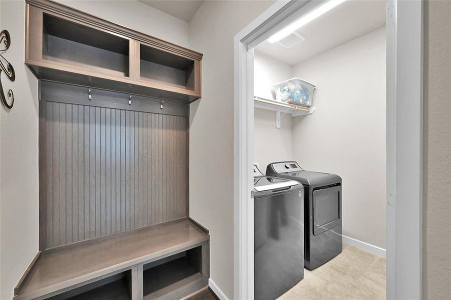 Just off the 3 car tandem garage is a mudroom that strategically leads into your laundry room.  The mudroom provides ample storage space for backpacks, jackets, shoes, etc. while the laundry room is spacious and has shelving for storing laundry supplies.