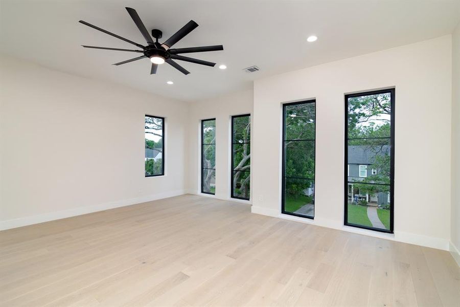 Unfurnished room featuring ceiling fan and light hardwood / wood-style flooring