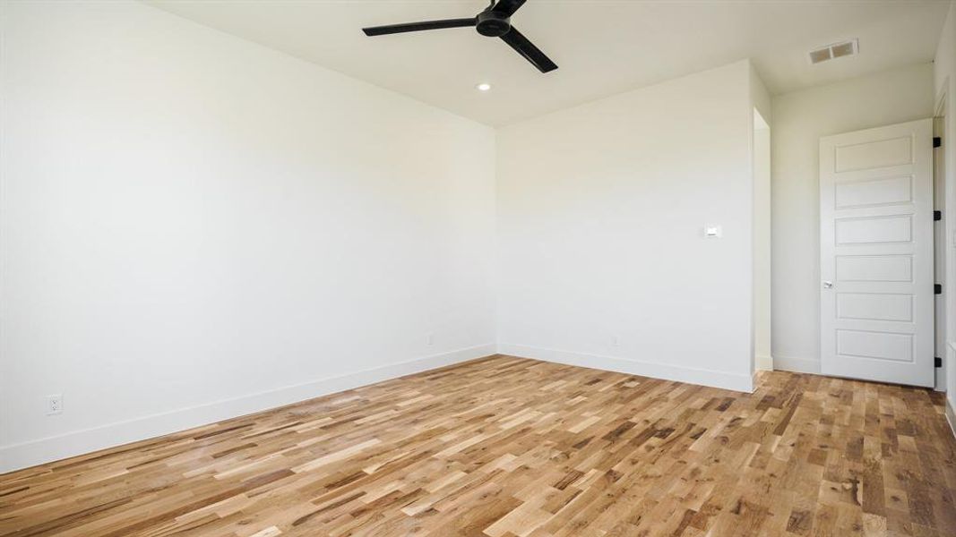 Unfurnished room with light hardwood / wood-style floors and ceiling fan