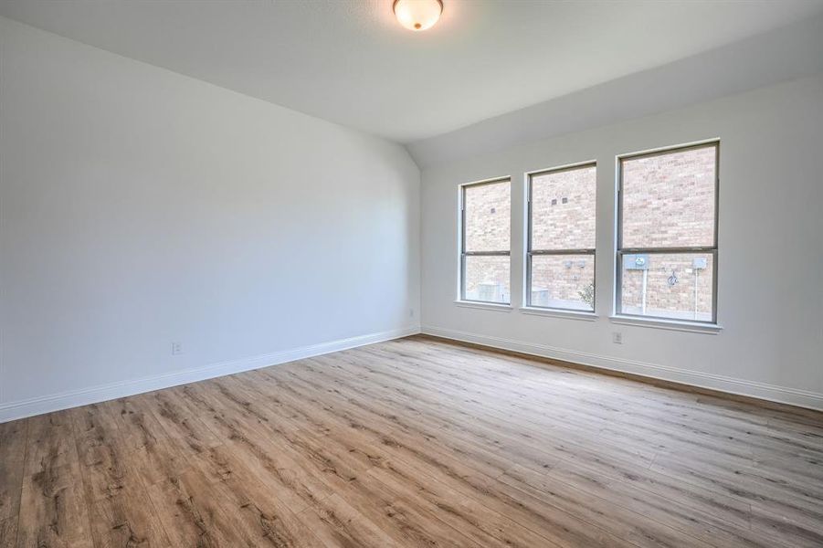Empty room featuring wood-type flooring