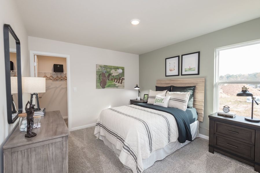 Take a look at this spacious bedroom featuring a private walk-in closet.