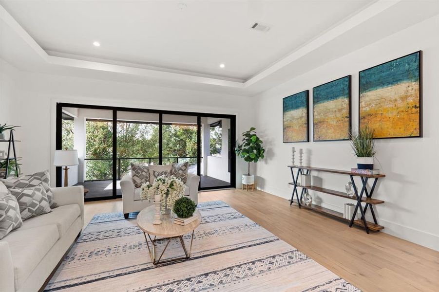 An additional view of the Secondary Living Space on second floor featuring a sliding glass door to the oversized balcony with gorgeous view!