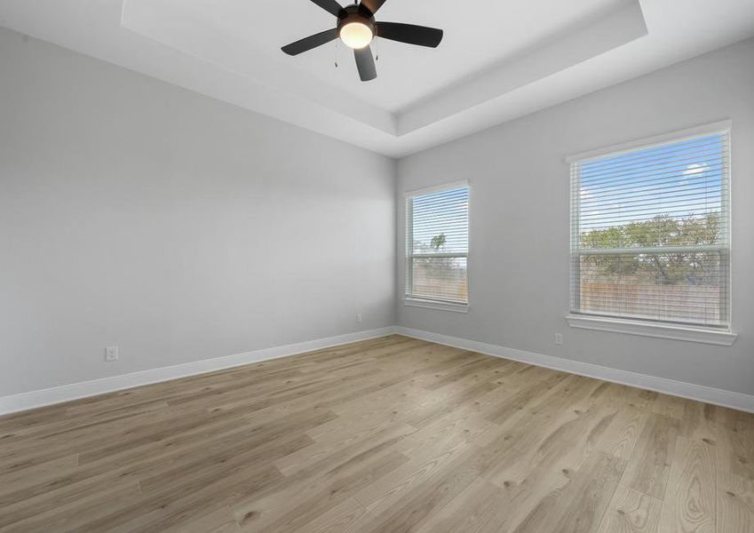 Relax at the end of the day in the serene master bedroom.