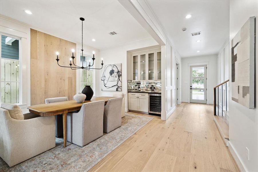 The mahogany front door is stained on the outside and painted on the inside with glass panels to allow in extra light. The entry foyer has floor to ceiling block paneling to provide dimension and character and it continues up the wide staircase to the second floor.