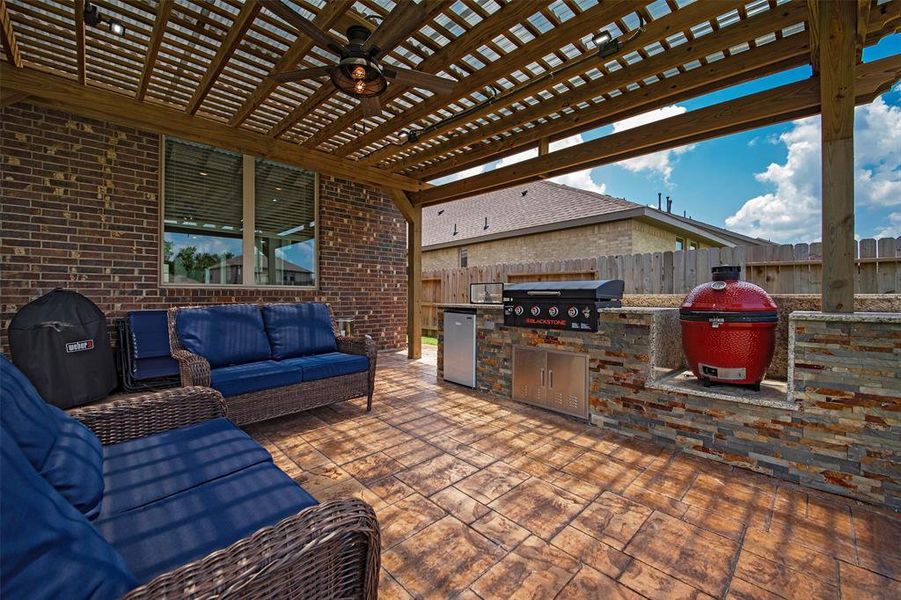 A custom outdoor kitchen that is a showplace.  Grill and Egg will stay.  Stained pavers used on sidewalk from gate to back porch.  Really makes a statement.